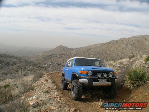 Blue 2007 Toyota FJ Cruiser on a dusty mountain trail with large tires