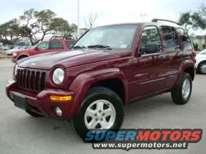 Maroon Jeep Liberty parked outside
