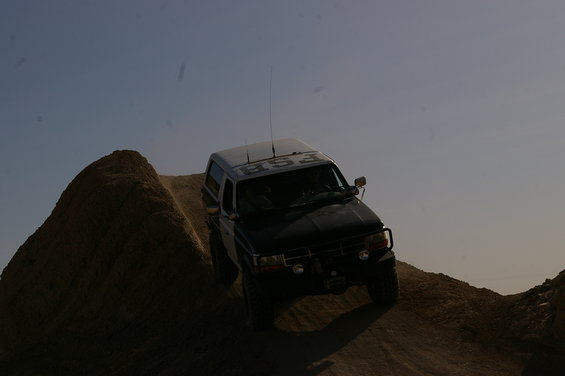 1992 Ford Bronco climbing a steep dirt hill, text 'FSB' on roof