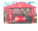 1998 Ford Crown Victoria - A red car is parked under a red shelter with its hood open.