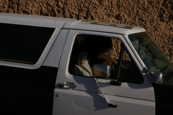 Side view of a 1986 Ford Bronco with two occupants