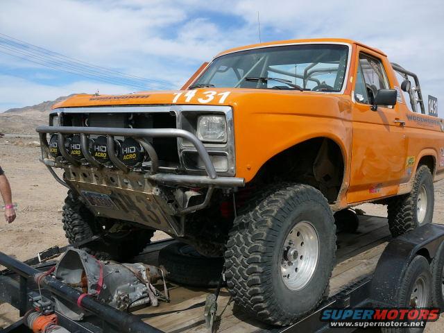 Orange 1988 Ford Bronco with racing number 1431 and off-road lights
