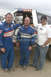 1998 Chevrolet C/K Pickup - Three men pose in front of a custom race truck, possibly a modified pickup.