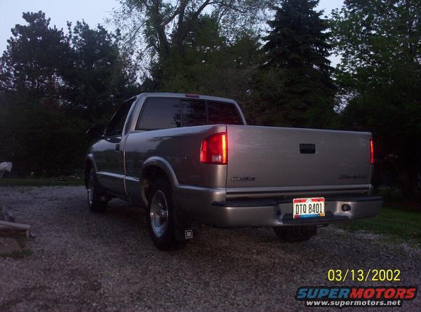 Silver 2003 Chevrolet S10 pickup truck, rear 3/4 view, parked on gravel