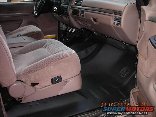 Interior view of vehicle with cloth seats and dashboard