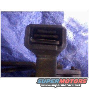 Close-up of a transmission part against a blue tarp. Supermotors.net logo visible