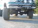 1996 Ford Bronco - This 1996 Ford Bronco features a lifted suspension, large off-road tires, and a front-mounted winch.