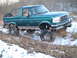 1996 Ford Bronco - This lifted 1996 Ford Bronco navigates a snowy, grassy terrain, its off-road capabilities with oversized tires and a custom roll cage.