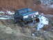 1996 Ford Bronco - This modified Ford Bronco is navigating a challenging off-road terrain with snow and rocks.