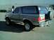 1989 Ford Bronco - This 1989 Ford Bronco is shown from the rear quarter angle, a spare tire mounted externally.