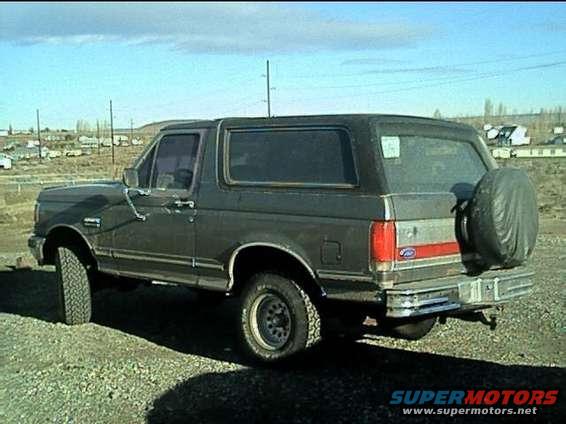 Dark gray 1989 Ford Bronco rear quarter view with spare tire