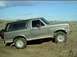 1989 Ford Bronco - This 1989 Ford Bronco is parked on a dirt lot under a cloudy sky.