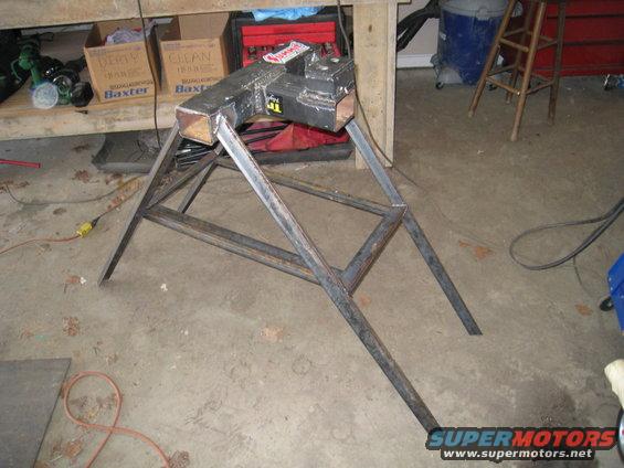 Metal vise mounted on a metal stand in a garage