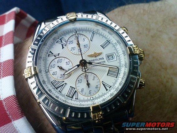 Close-up of a Breitling Chronometre watch with Roman numerals and gold accents