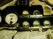 1976 Ford Ranchero - A collection of automotive gauges, some with white faces, are laid out on a surface covered with newspaper.