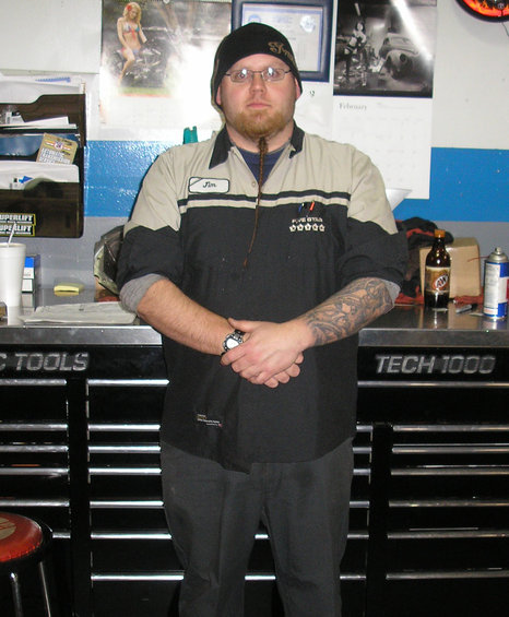 Man in garage with tool chests and calendars