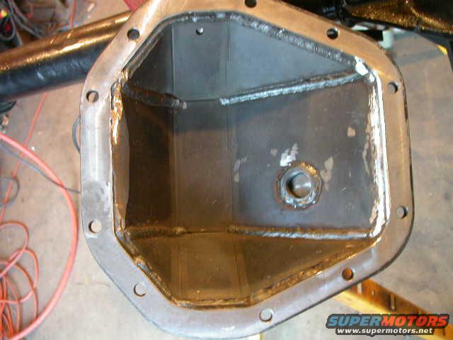 dscn6069.jpg I did end up needing to do a little clearancing in the diff cover.  I wasn't too surprised to need to grind down the welds a bit on the non-ring gear side to clear the air line.  I was a little surprised that I had to grind down a bit on the ring gear side to clear the bearing cap.  I wouldn't have thought that would be a problem, but it was.