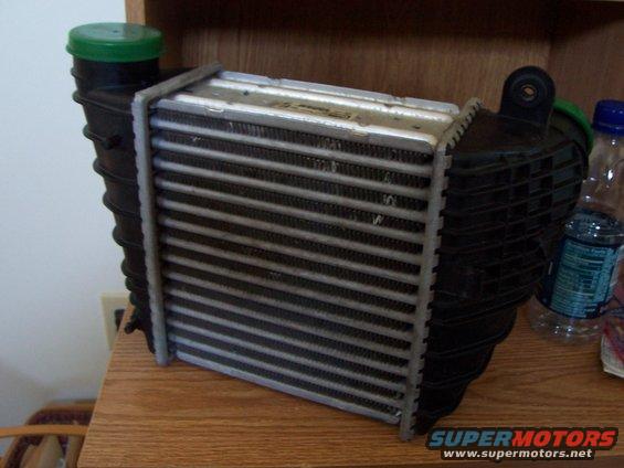 Intercooler with black plastic end tanks and green cap