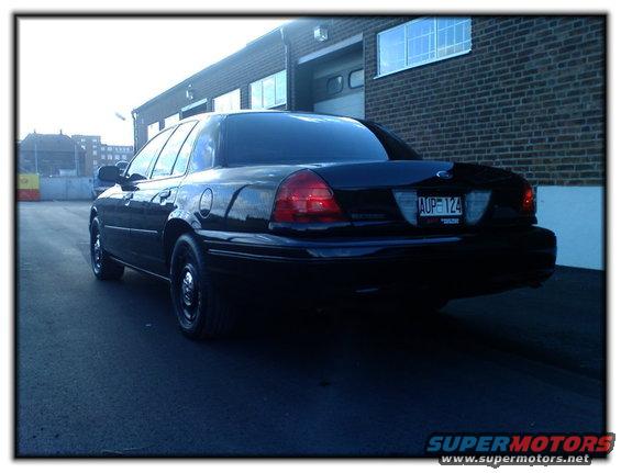 Black 1998 Ford Crown Victoria rear view with license plate AUP 124
