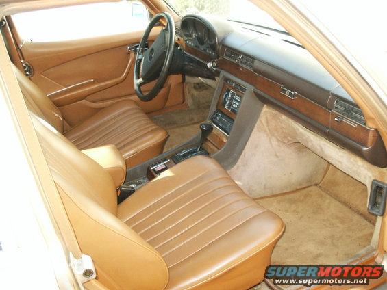 Tan interior of a 1980 Mercedes-Benz S-Class, showing seats, dashboard, and steering wheel