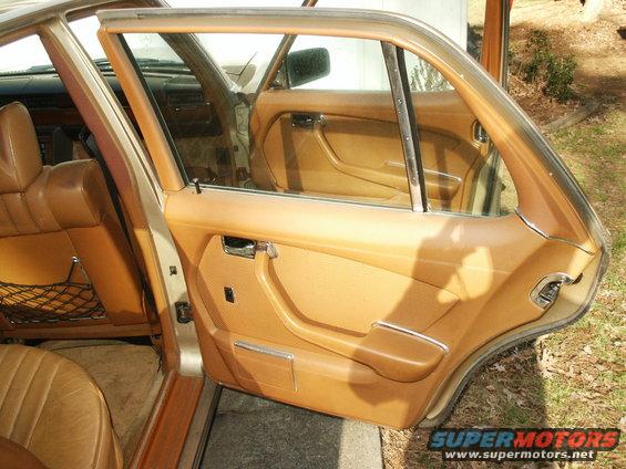 Interior shot of a 1980 Mercedes-Benz S-Class, showing the tan door panel and seats