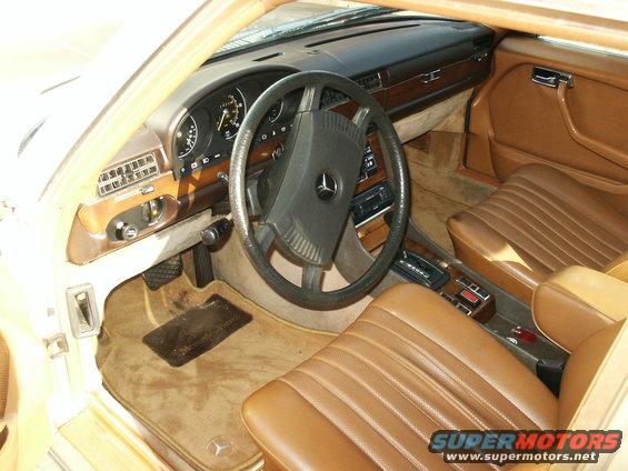 1980 Mercedes-Benz S-Class interior with brown leather seats, wood trim, and dashboard gauges