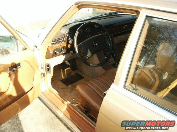 Tan interior of a 1980 Mercedes-Benz S-Class with wood trim and brown leather seats