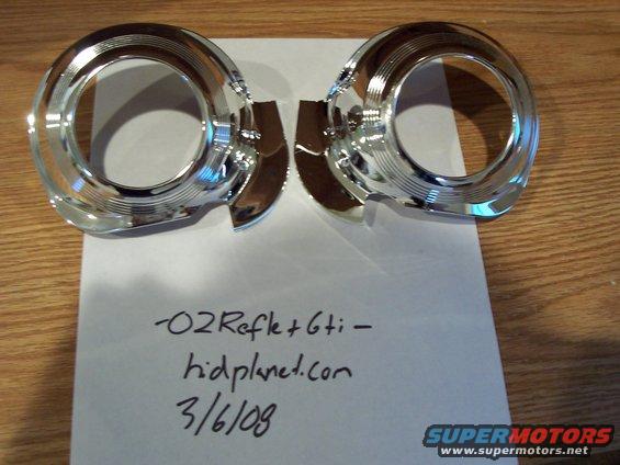 Two chrome headlight trim rings on a piece of paper with handwritten text