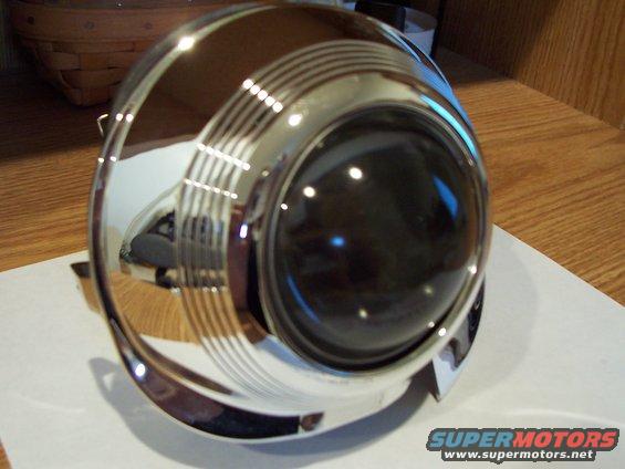 Chrome headlight assembly with concentric rings around a dark lens
