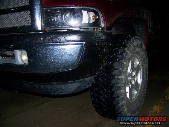 2001 Dodge 1500 front corner with large off-road tires and chrome bumper