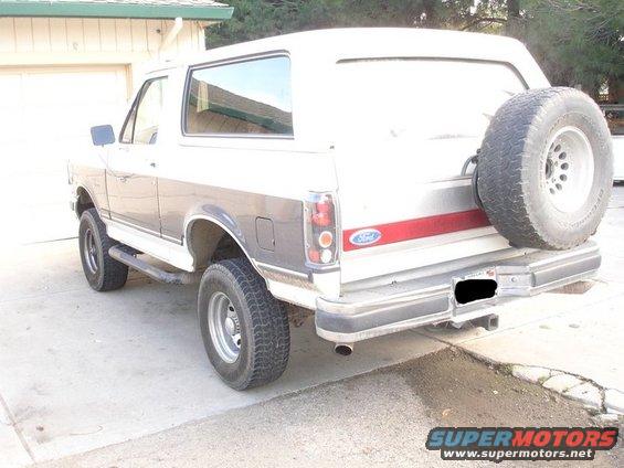 White 1989 Ford Bronco rear view with spare tire mounted on tailgate