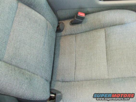 close-up of gray fabric car seats with seatbelt buckle visible