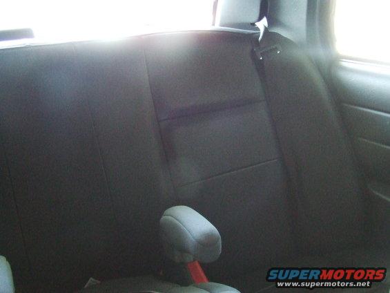 Black vinyl rear seat with headrest and seatbelt in a 2003 Ford Crown Victoria