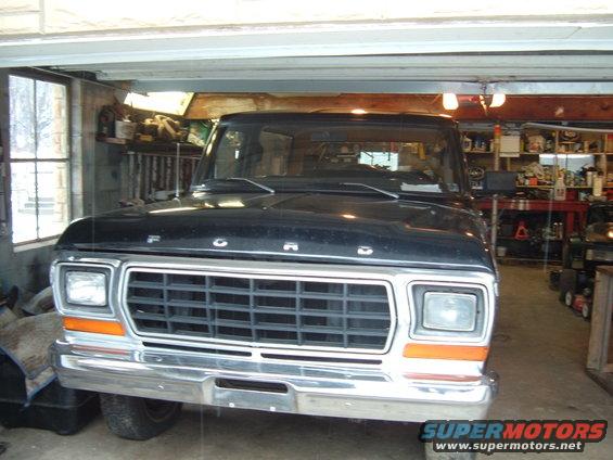 Front view of a black 1979 Ford F-Series truck grille and headlights