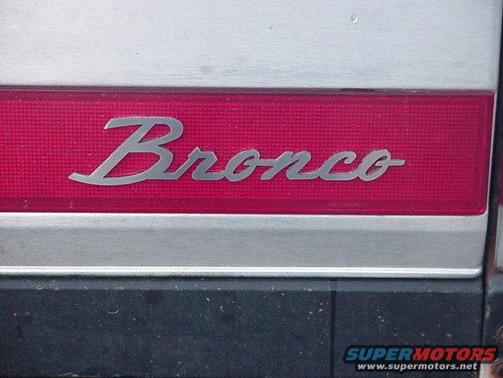Bronco emblem on a silver and red panel, with a black bumper below