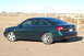 1998 Audi A6 - This Audi sedan is parked outdoors on a dirt lot with a fence and some brush in the background.