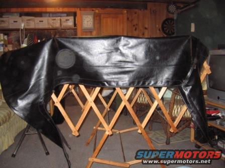 The top itself, driver's side. Left side goes towards front of truck. No tears, cuts or scratches in top.