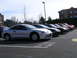2007 Mazda 3 - Several coupes are parked in a lot on a sunny day.