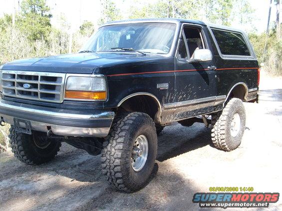 Black 1992 Ford Bronco with lifted suspension and off-road tires, viewed from a 3/4 front angle