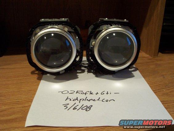 Two projector headlights with a handwritten note that says "O2Refle+Gti - hidplanet.com 3/6/08"