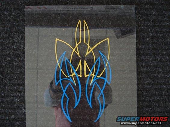 Pinstripe decal with blue and yellow flames on a reflective surface