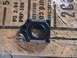 2007 Yamaha YZ450F - Black motorcycle part with circular opening sits on a wooden surface with visible text.
