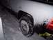 2008 Chevrolet Silverado 1500 - 2008 Chevrolet Silverado 1500 rear tire in snow, showing tire tracks and a portion of the taillight.