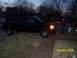 2008 Chevrolet Silverado 1500 - Black pickup truck parked in a driveway at dusk with a person standing nearby.