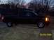 2008 Chevrolet Silverado 1500 - A black Chevrolet Silverado pickup truck is parked outside at dusk, showing its side profile.