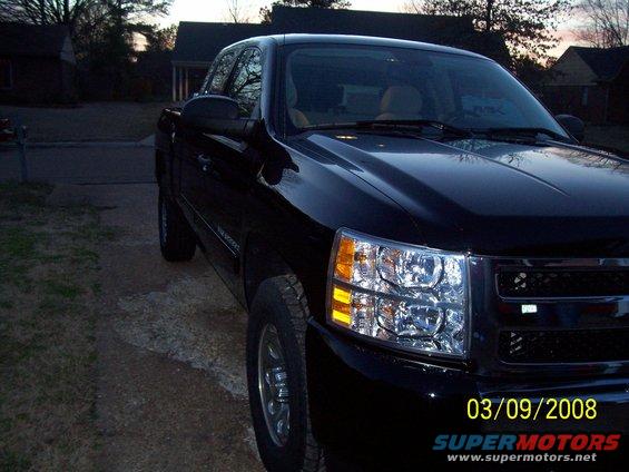 Black pickup truck front corner with visible date stamp 03/09/2008