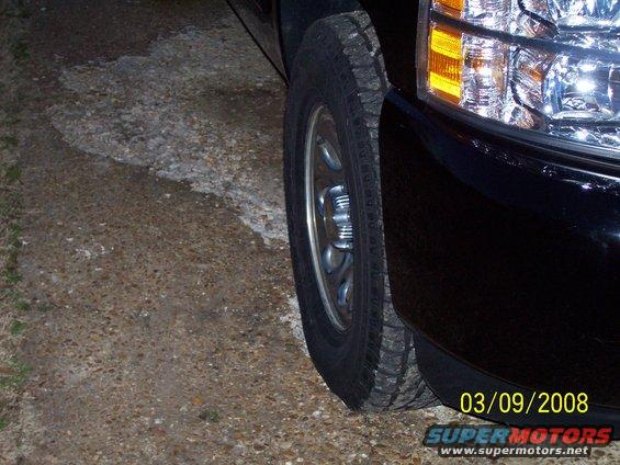 Front passenger side wheel and headlight of a black pickup truck. Date stamp reads 03/09/2008