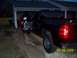 2008 Chevrolet Silverado 1500 - A black 2008 Chevrolet Silverado 1500 pickup truck is parked with the driver's door open, showing a person's legs inside.