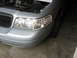 2004 Ford Crown Victoria - Front view of a 2004 Ford Crown Victoria with the hood raised, revealing the engine bay.