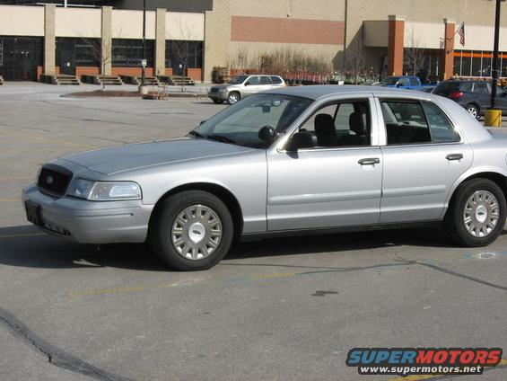 Silver 2004 Ford Crown Victoria parked in a lot